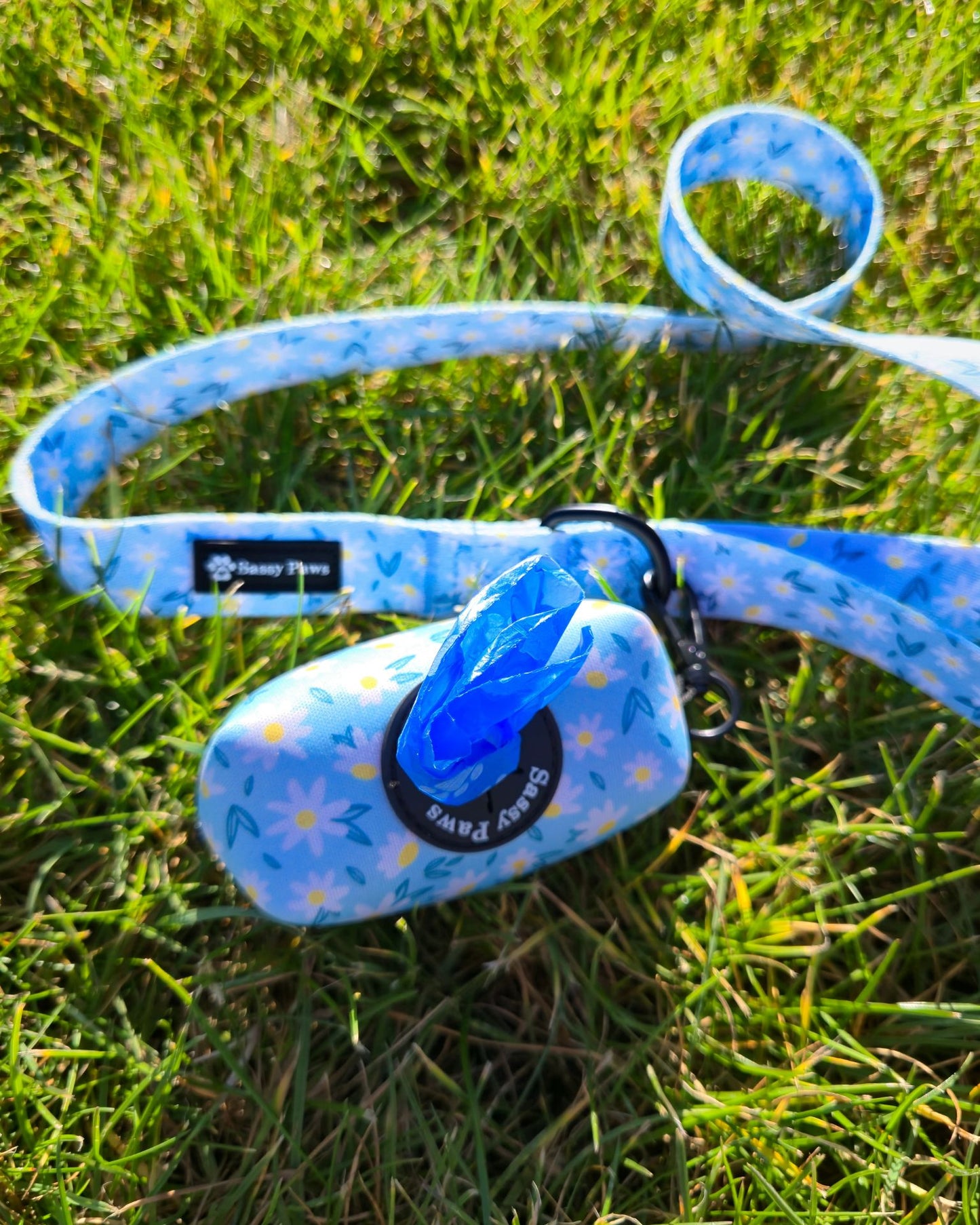 Blue with small white flowers Sassy Paws Waste Bag Holder with black clip and matching lead or leash Black finishings